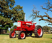 TRA 01 RK0121 01
1958 Farmall 350 High Clearance Red And White 3/4 Front View On Grass By Trees