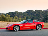 VET 01 RK0934 01
2010 Chevrolet Corvette Grand Sport Red 3/4 Front View On Pavement By Hills