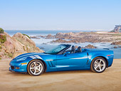 VET 01 RK0953 01
2010 Chevrolet Corvette Grand Sport Convertible Blue 3/4 Side View On Beach By Houses