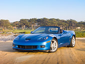 VET 01 RK0954 01
2010 Chevrolet Corvette Grand Sport Convertible Blue 3/4 Front View On Sand By Trees