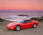 VET 01 RK0315 11
1999 Chevrolet Corvette Hardtop Red 3/4 Side View On Sand By Ocean