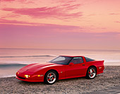 VET 01 RK0334 06
1990 Chevrolet Corvette Shinoda Red 3/4 Front View On Sand By Ocean