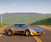 VET 01 RK0447 02
1982 Chevrolet Corvette Crossfire Injection Gold Side 3/4 View On Road Hills Background