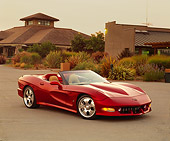 VET 01 RK0594 01
2002 Avelate Corvette Roadster Red 3/4 Side View On Pavement By Building And Bushes