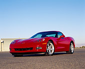 VET 01 RK0668 01
2005 Chevy Corvette C6 Red 3/4 Low Front View On Pavement By Hangar