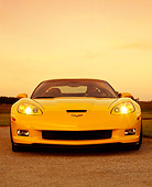 VET 01 RK0731 03
2006 Chevrolet, Corvette, Z06, Yellow Low Head On View With Driver On Pavement By Grass