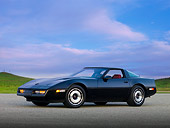 VET 01 RK0824 01
1984 Chevrolet Corvette Coupe Black 3/4 Front View On Pavement By Hill Blue Sky