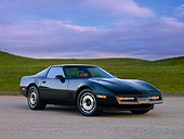 VET 01 RK0825 01
1984 Chevrolet Corvette Coupe Black 3/4 Front View On Pavement By Hill Blue Sky