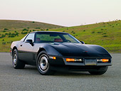 VET 01 RK0826 01
1984 Chevrolet Corvette Coupe Black 3/4 Front View On Pavement By Hill Blue Sky