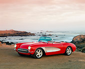 VET 02 RK0159 10
1957 Chevrolet Corvette Custom Convertible Red And White 3/4 Side View On Sand By Ocean Filtered