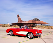 VET 02 RK0284 02
1957 Chevrolet Corvette Convertible Red White Cove 3/4 Front View On Pavement By Fighter Jet