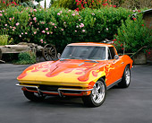 VET 03 RK0303 01
1963 Chevrolet Corvette Split Window Coupe Orange With Yellow Flames 3/4 Front View On Pavement By Pink Flowers