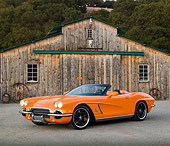 VET 03 RK0700 01
1962 Chevrolet Corvette Convertible Orange 3/4 Front View On Pavement By Old Barn
