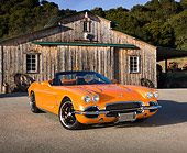 VET 03 RK0702 01
1962 Chevrolet Corvette Convertible Orange 3/4 Front View On Pavement By Old Barn