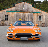 VET 03 RK0703 01
1962 Chevrolet Corvette Convertible Orange Front View On Pavement By Old Barn