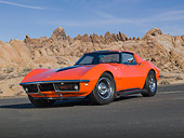 VET 03 RK0776 01
1968 Chevrolet Corvette Orange With Black Stripe 3/4 Front View On Pavement By Rocks