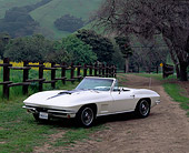 VET 03 RK0042 01
1967 Chevy Corvette 427 Convertible White 3/4 Front View On Dirt By Fence And Trees