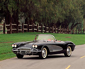VET 03 RK0049 10
1961 Chevrolet Corvette Convertible Black And Gray Front 3/4 View On Pavement By Trees And Fence
