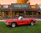 VET 03 RK0187 03
1961 Chevrolet Corvette Convertible Red 3/4 Side View On Grass By Store