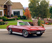VET 03 RK0196 02
1967 Chevrolet Corvette 327 Convertible Burgundy 3/4 Front View On Pavement By House