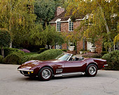VET 03 RK0215 02
1969 Chevrolet Corvette Stingray Convertible Burgundy 3/4 Side View On Pavement By House And Trees