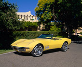 VET 03 RK0277 03
1968 Chevrolet Corvette 427 Convertible Yellow 3/4 Front View On Pavement By Trees And Bushes