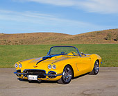 VET 03 RK0371 06
1962 Extreme Chevrolet Corvette Convertible Yellow 3/4 Front View On Pavement By Grass Blue Sky