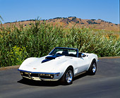 VET 03 RK0410 05
1969 Chevrolet Corvette 427 Convertible White And Black Front 3/4 View On Pavement By Bushes