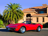 VET 03 RK0538 01
1969 Chevrolet Corvette Stingray Convertible Red 3/4 Front View On Pavement By Palm Tree Building