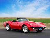 VET 03 RK0542 01
1969 Chevrolet Corvette Stingray Convertible Red 3/4 Front View On Pavement By Field And Sky