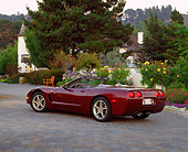 VET 04 RK0031 02
2003 Chevrolet Corvette 50th Anniversary Edition Burgundy Rear 3/4 View On Driveway By Flowers And Trees