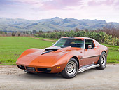 VET 05 RK0221 01
1974 Chevrolet Corvette Sunburst Yellow 3/4 Front View On Gravel By Grass Field And Hills