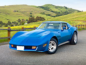 VET 05 RK0229 01
1975 Chevrolet Corvette Blue 3/4 Front View On Pavement By Fence And Grassy Hills