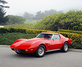 VET 05 RK0129 02
1973 Chevrolet Corvette Coupe Red 3/4 Front View On Pavement By Bushes