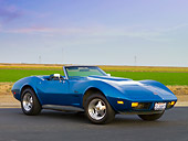 VET 05 RK0155 01
1974 Chevrolet Corvette Convertible Blue 3/4 Front View On Pavement By Field And Blue Sky