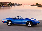 VET 05 RK0156 01
1974 Chevrolet Corvette Convertible Blue 3/4 Front View On Pavement By Canal And Homes