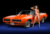 WMN 03 RK0314 01
1969 Pontiac GTO Judge Orange 3/4 Front View In Studio With Swimsuit Model