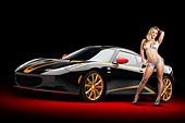 WMN 03 RK0317 01
2012 Lotus Evora S GP Edition Black And Gold 3/4 Front View In Studio With Swimsuit Model